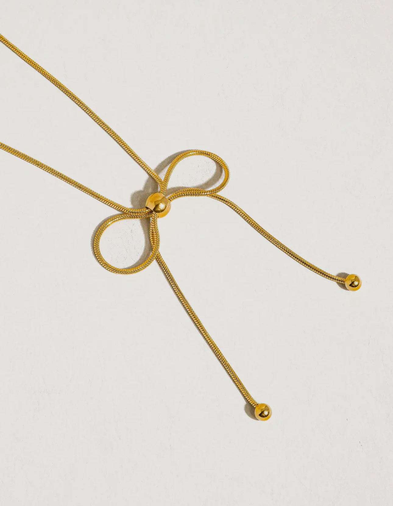 Gold bow necklace